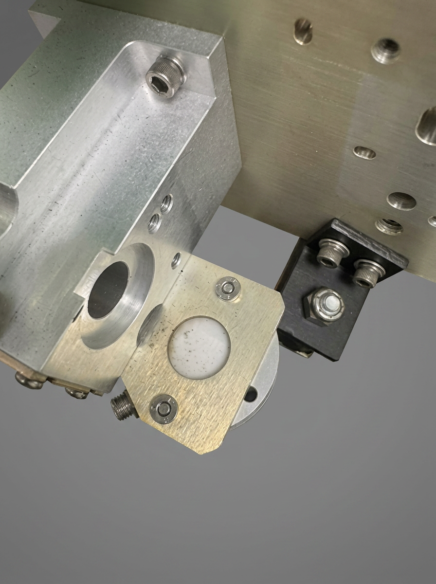 Aperture & Shutter — Beam aperture and shutter plate cleaned and re-seated. Any pitting or debris on the aperture edge shows up immediately in beam profile tests.